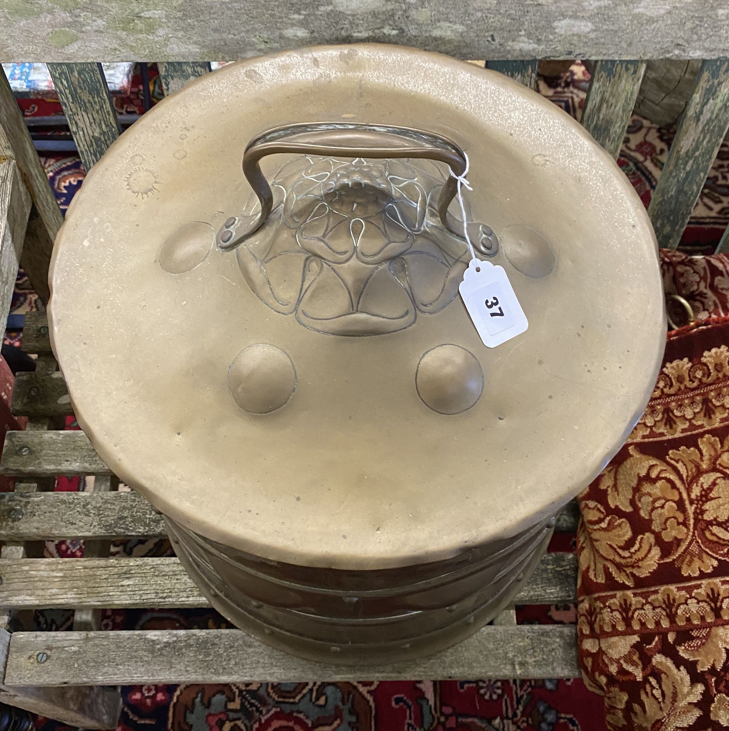 An Arts & Crafts circular embossed brass coal bin, diameter 42cm, height 46cm